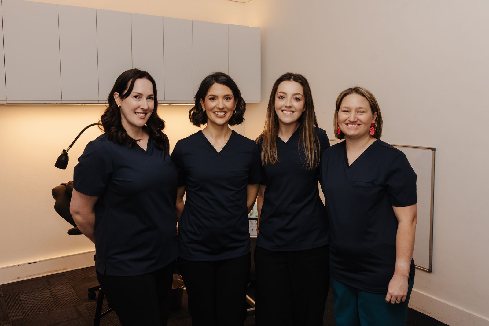 The Brave Steps Health team, Rachel Dickey, Renee Collins, Sophie Carrington and Hayley Lambert, smiling together at the Gladesville clinic