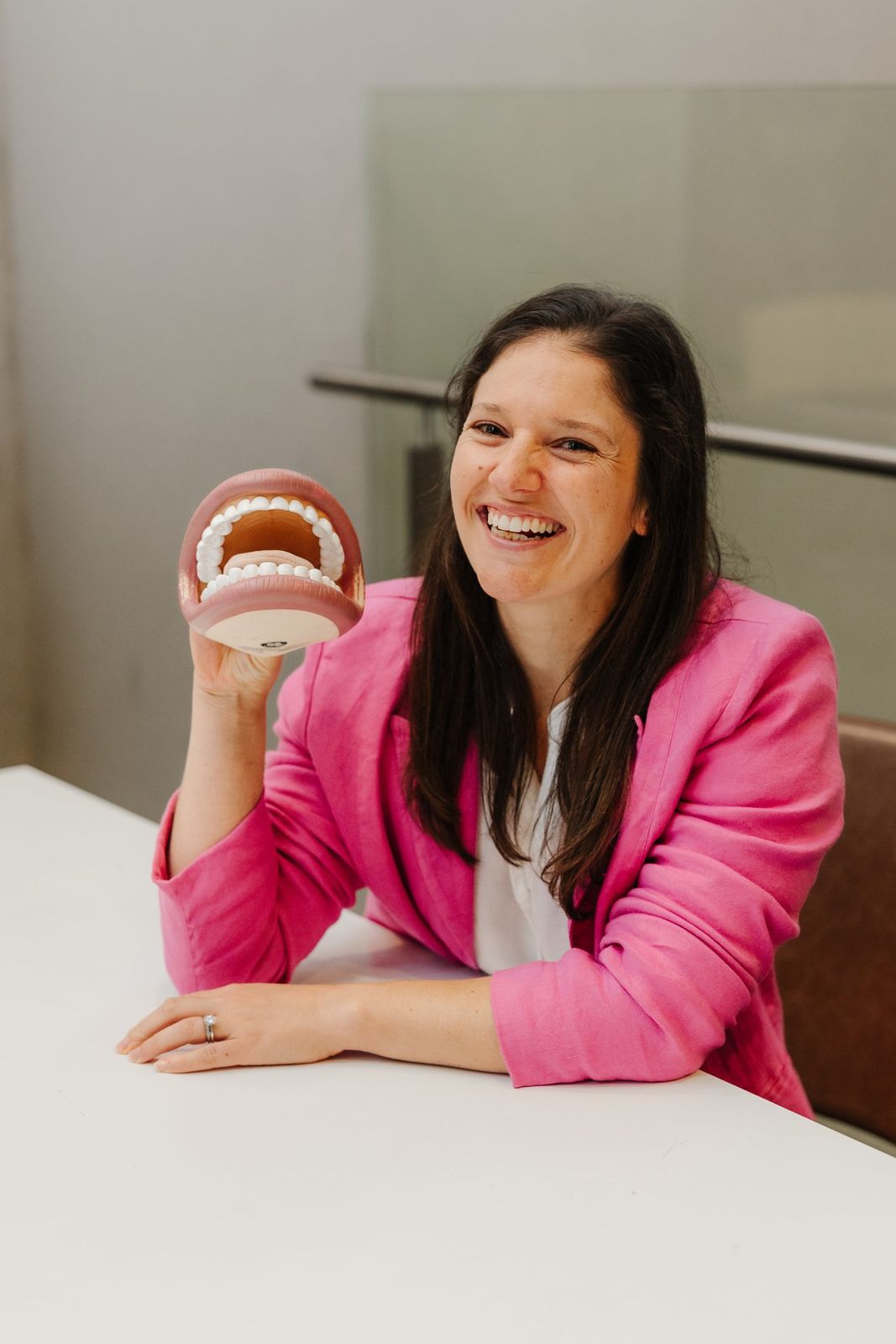 Brave Steps Health clinician holding a dental model used to prepare children and adults for dental appointments